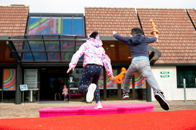 Children jumping outside Baycourt