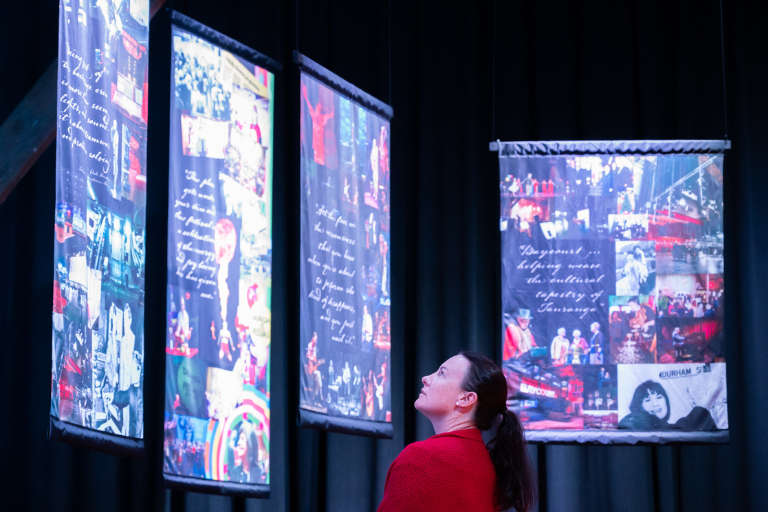 Person looking up at history banners