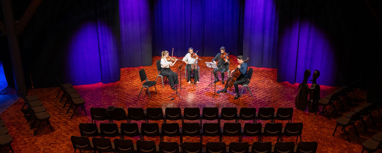 X Space configured for an intimate live performance by string quartet.